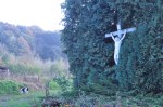 Jesus on a crucifix, in a hedge